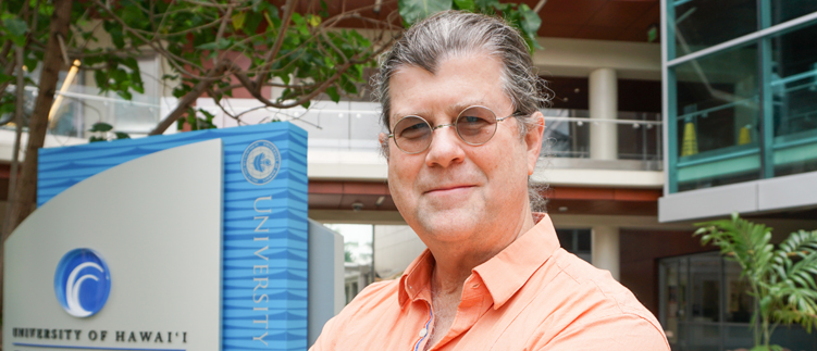 John Shepherd, PhD in front of the UH Cancer Center building